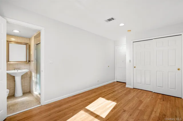a view of a room with wooden floor and white walls