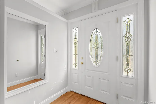 a view of a livingroom with wooden floor and white doors