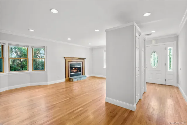 a view of a livingroom with wooden floor and a ceiling fan