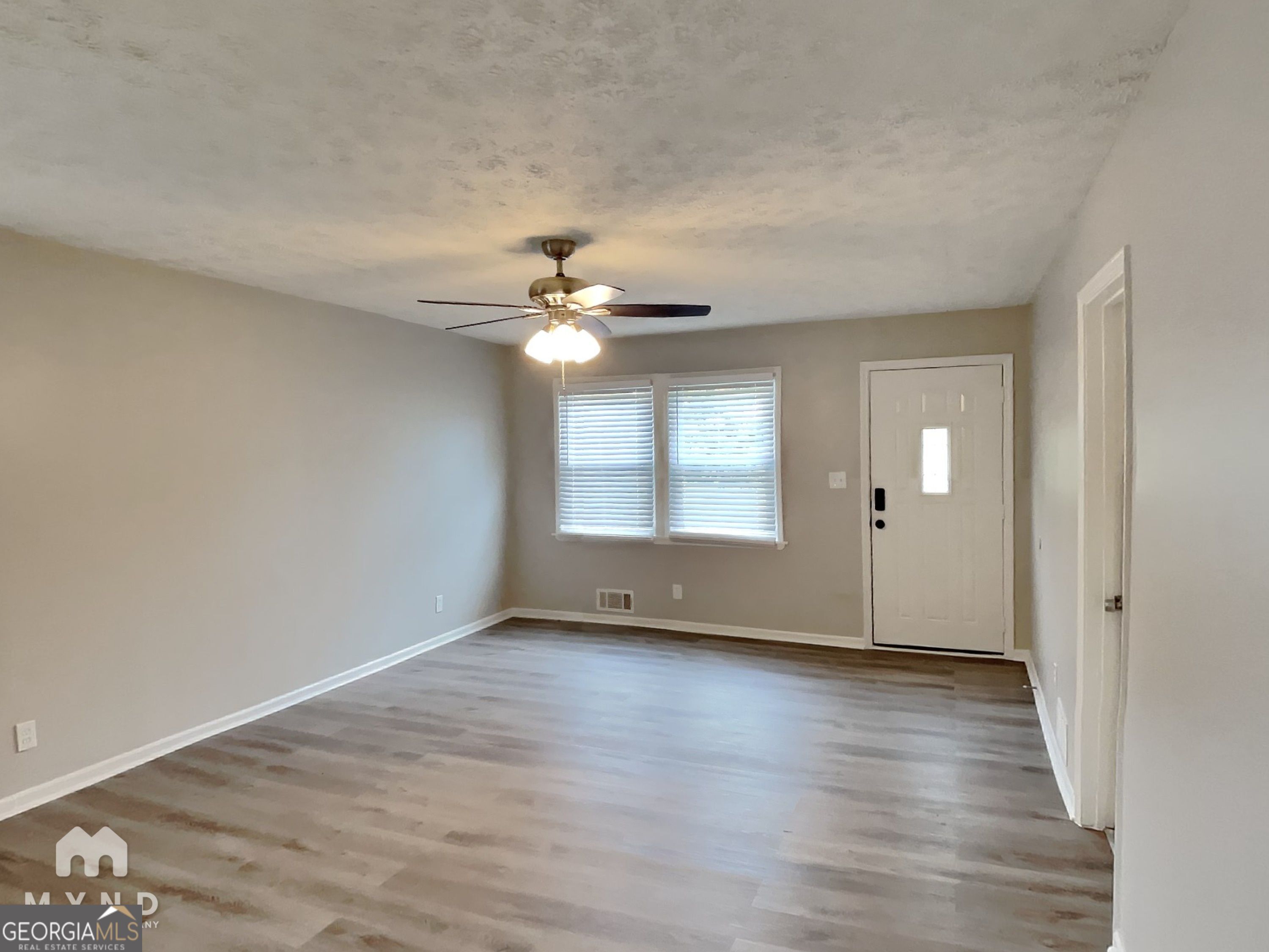 3821 Rex Circle Rex, GA 30273 - Photo 2 of 16 a view of an empty room with wooden floor and a window