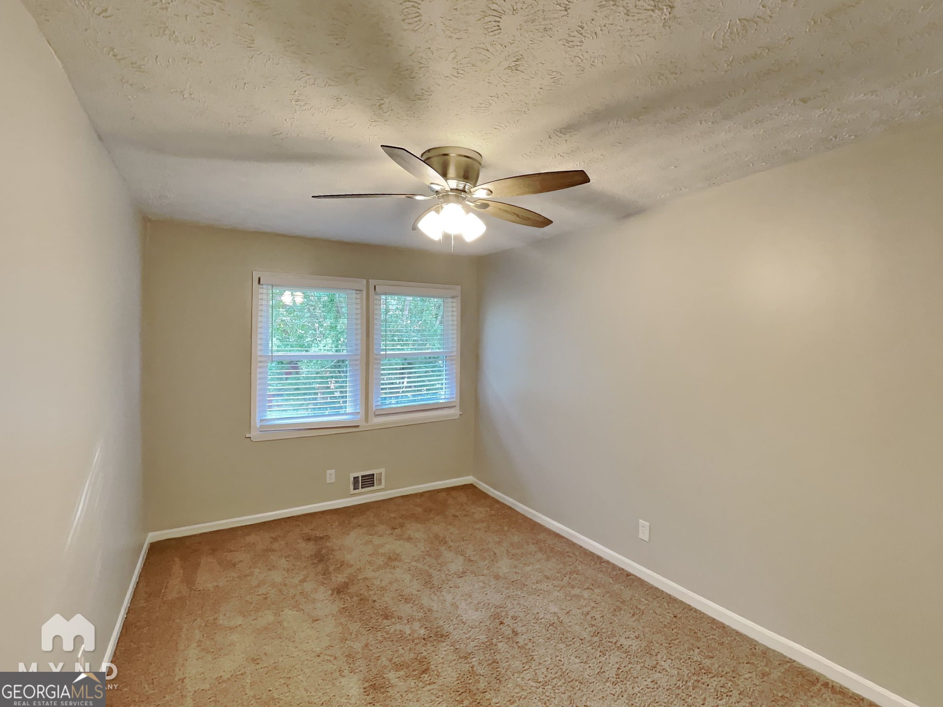 3821 Rex Circle Rex, GA 30273 - Photo 8 of 16 an empty room with windows and fan