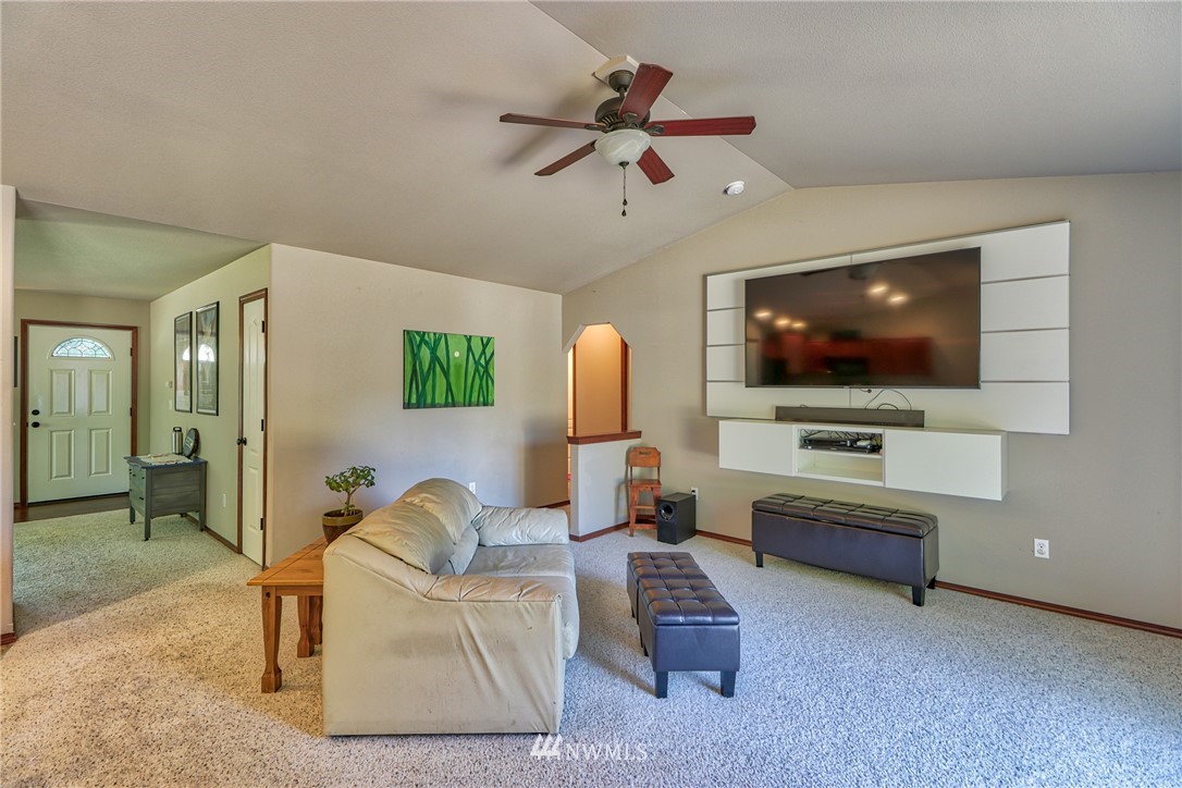 18047 Prairie Pointe Lane Southwest Rochester, WA 98579 - Photo 11 of 25 a living room with furniture and a flat screen tv