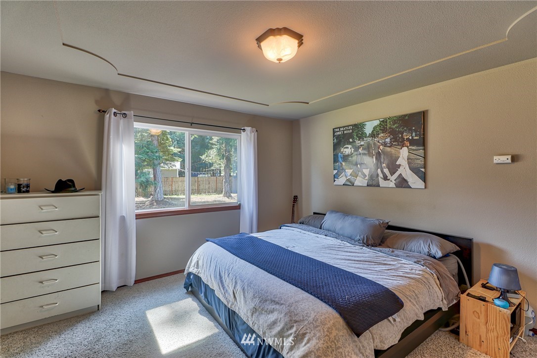 18047 Prairie Pointe Lane Southwest Rochester, WA 98579 - Photo 14 of 25 a bedroom with a bed and a window