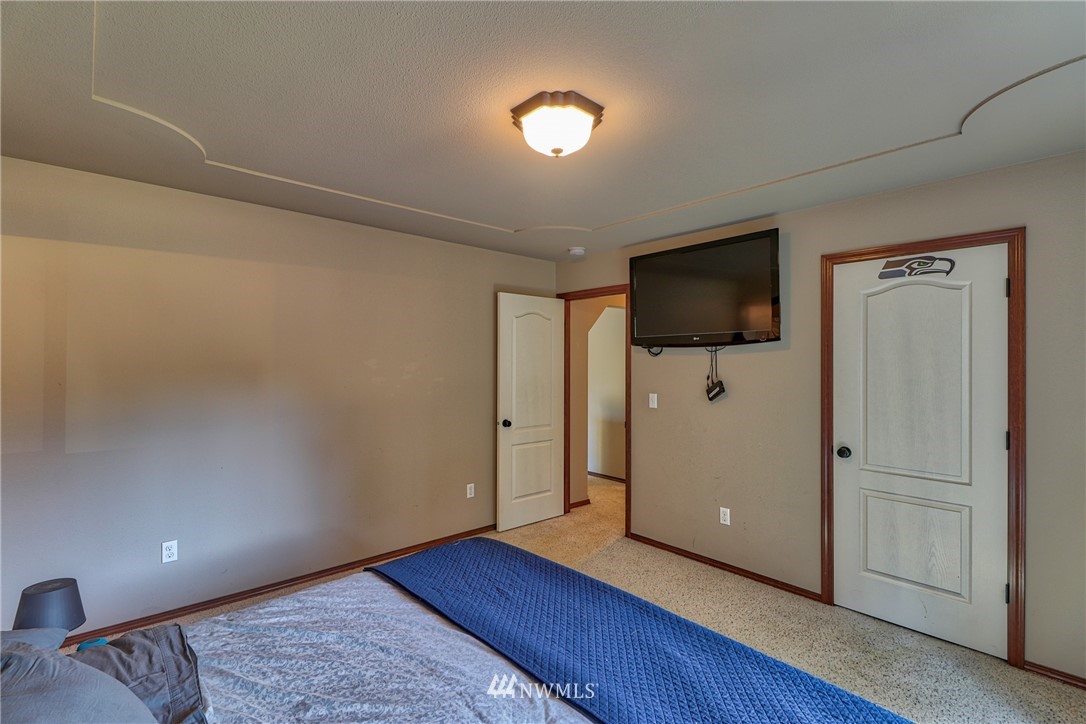 18047 Prairie Pointe Lane Southwest Rochester, WA 98579 - Photo 15 of 25 a view of a livingroom with wooden floor and a flat screen tv