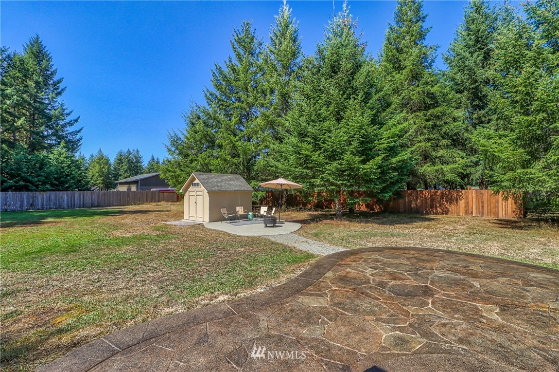 18047 Prairie Pointe Lane Southwest Rochester, WA 98579 - Photo 21 of 25 a front view of a house with a yard and trees