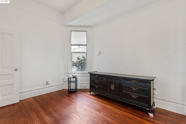a view of room with furniture and wooden floor
