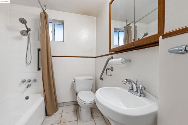 a large kitchen with stainless steel appliances a large counter top a refrigerator and a sink