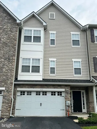 a view of a house with large windows and a small yard