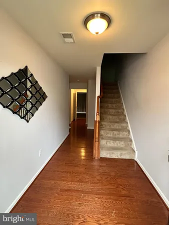 a view of entryway and hall with wooden floor