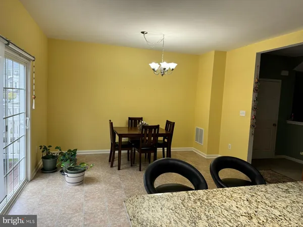 a view of a dining room with furniture and chandelier