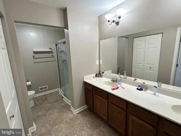 a bathroom with a double vanity sink and mirror