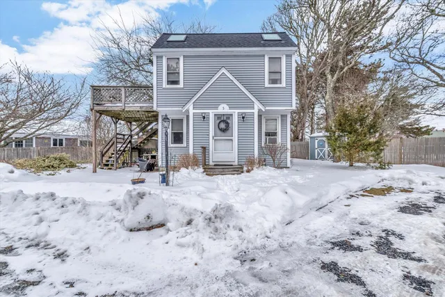 a view of a large house with a yard covered in snow