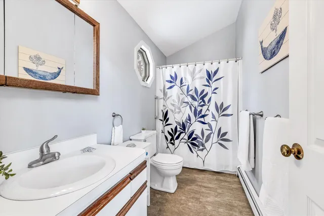 a bathroom with a sink and mirror with toilet