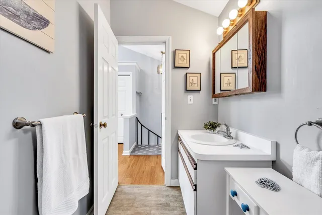 a bathroom with a sink toilet and mirror