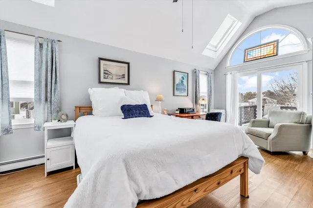 a bedroom with a bed and glass window