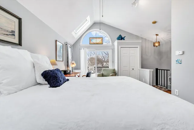 a bed room with a bed and a large window