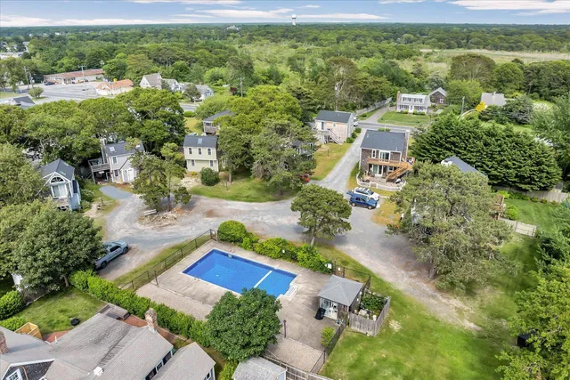 an aerial view of residential houses with outdoor space and street view