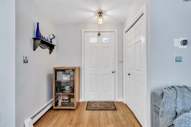 a view of a livingroom with wooden floor and a cabinet
