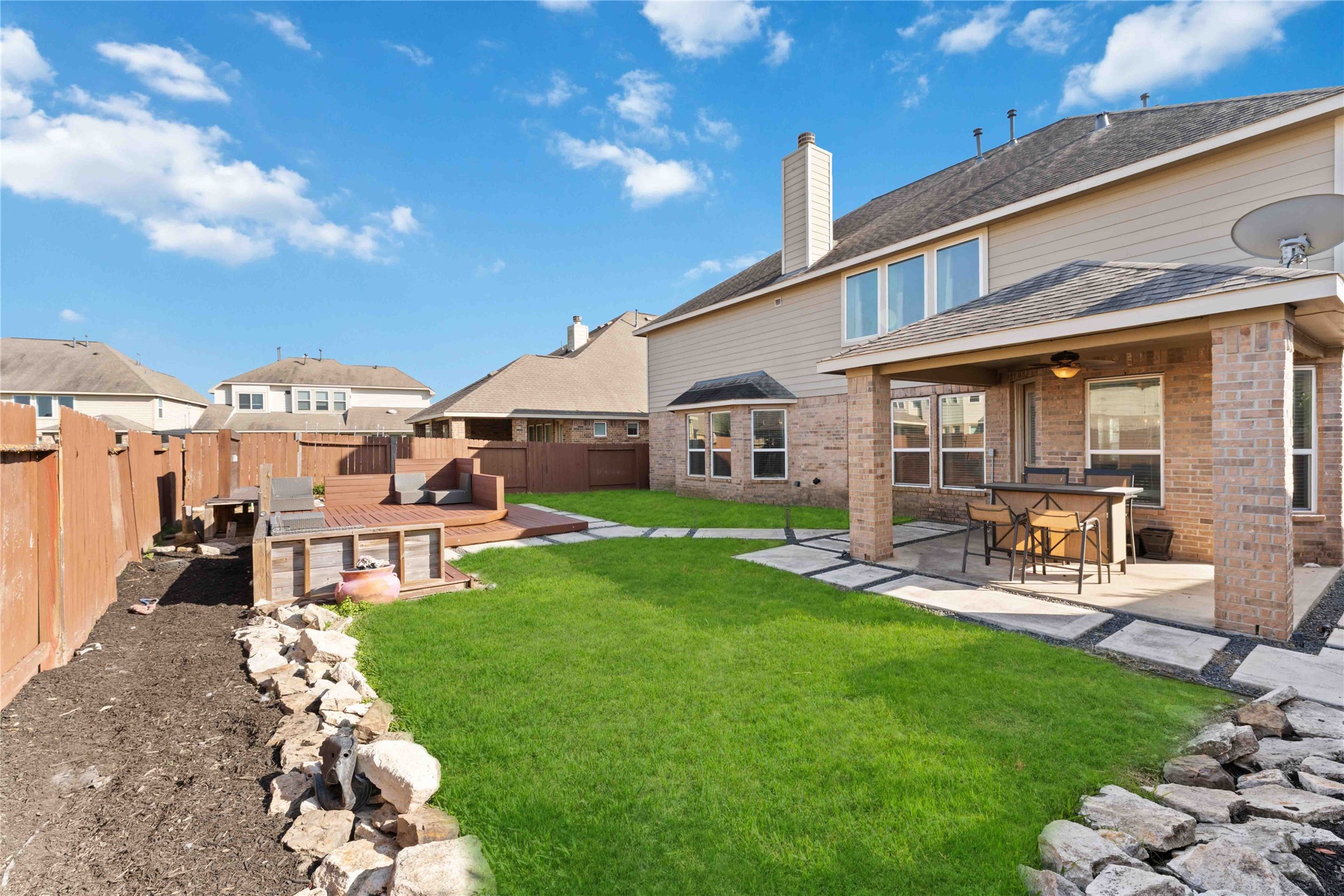7403 Dry Stone Lane Rosenberg, TX 77469 - Photo 18 of 19 Step into a backyard that feels open, inviting, and ready to be enjoyed. With generous green space and room to spread out, this yard is perfect for relaxing weekends, playtime, or hosting family and friends.