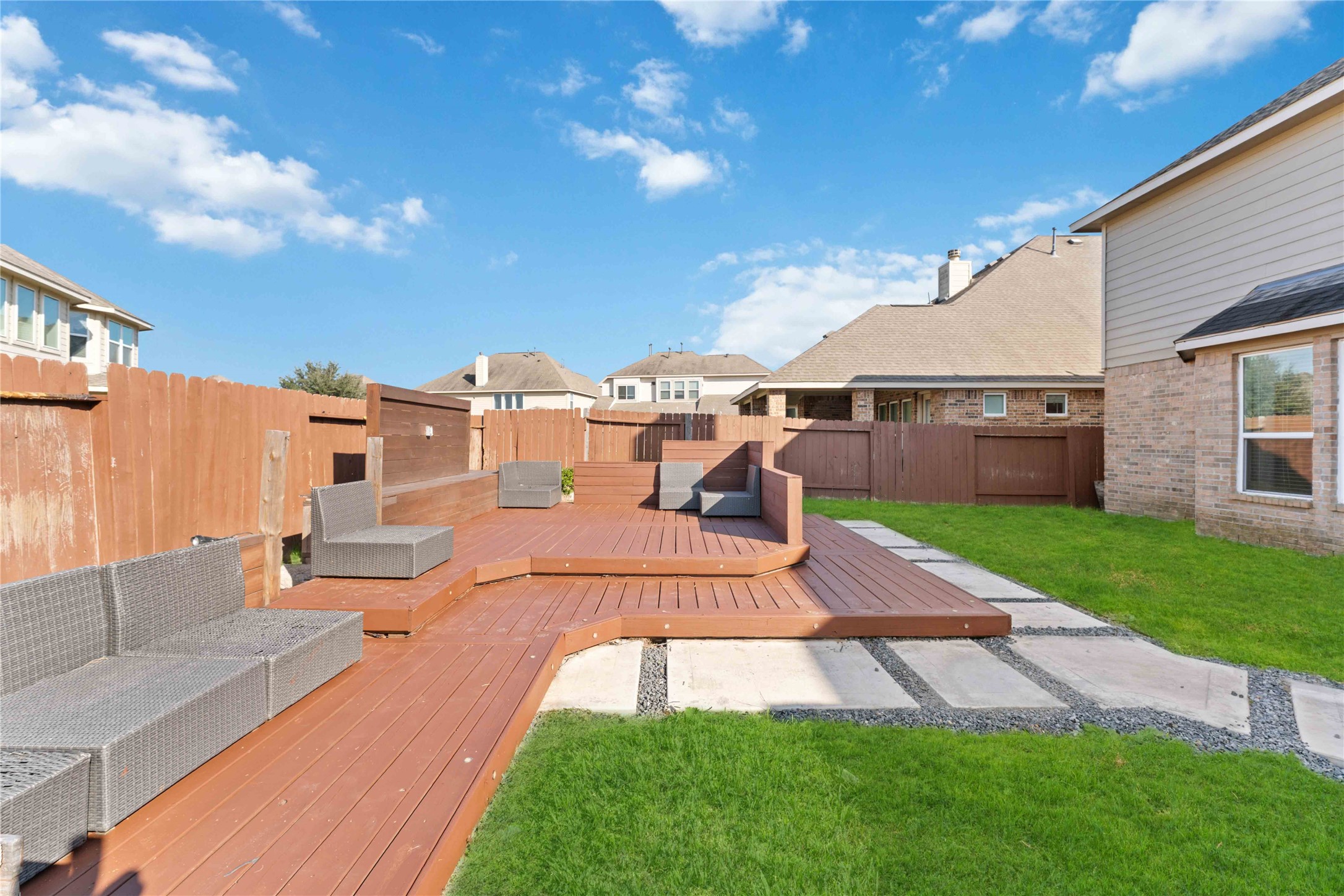 7403 Dry Stone Lane Rosenberg, TX 77469 - Photo 19 of 19 This custom built-in deck and fire pit create the heart of the backyard. It’s the kind of space where evenings stretch longer—a place where the laughter and jokes are made. Imagine retreating here after a long day!