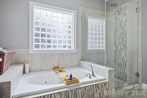 a bath tub sitting in a bathroom next to a window
