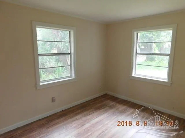 an empty room with wooden floor