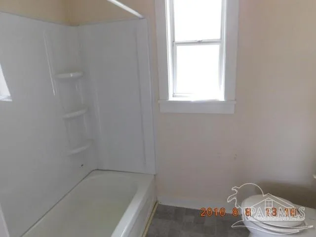 a bathroom with a window and a white sink