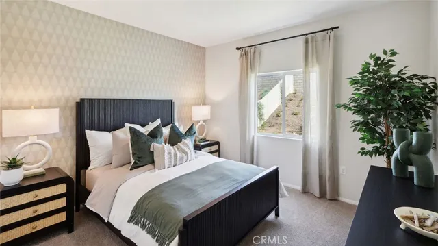 a bedroom with a bed and a potted plant