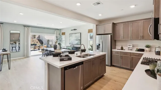 a kitchen with a sink stove and refrigerator