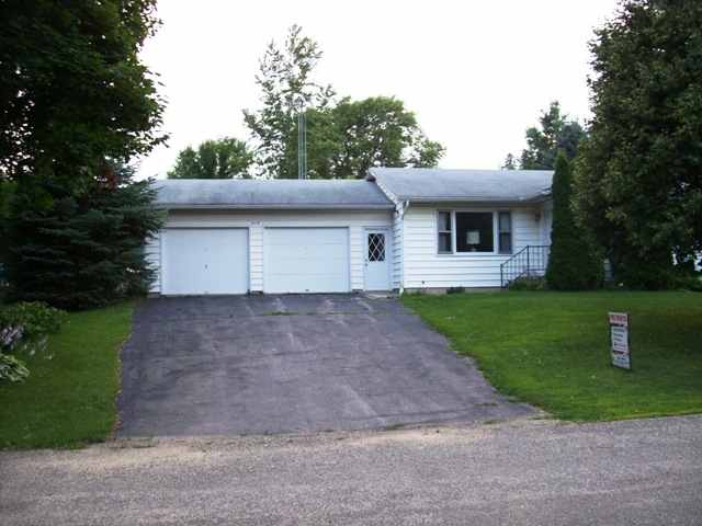 a front view of a house with a yard and a garage