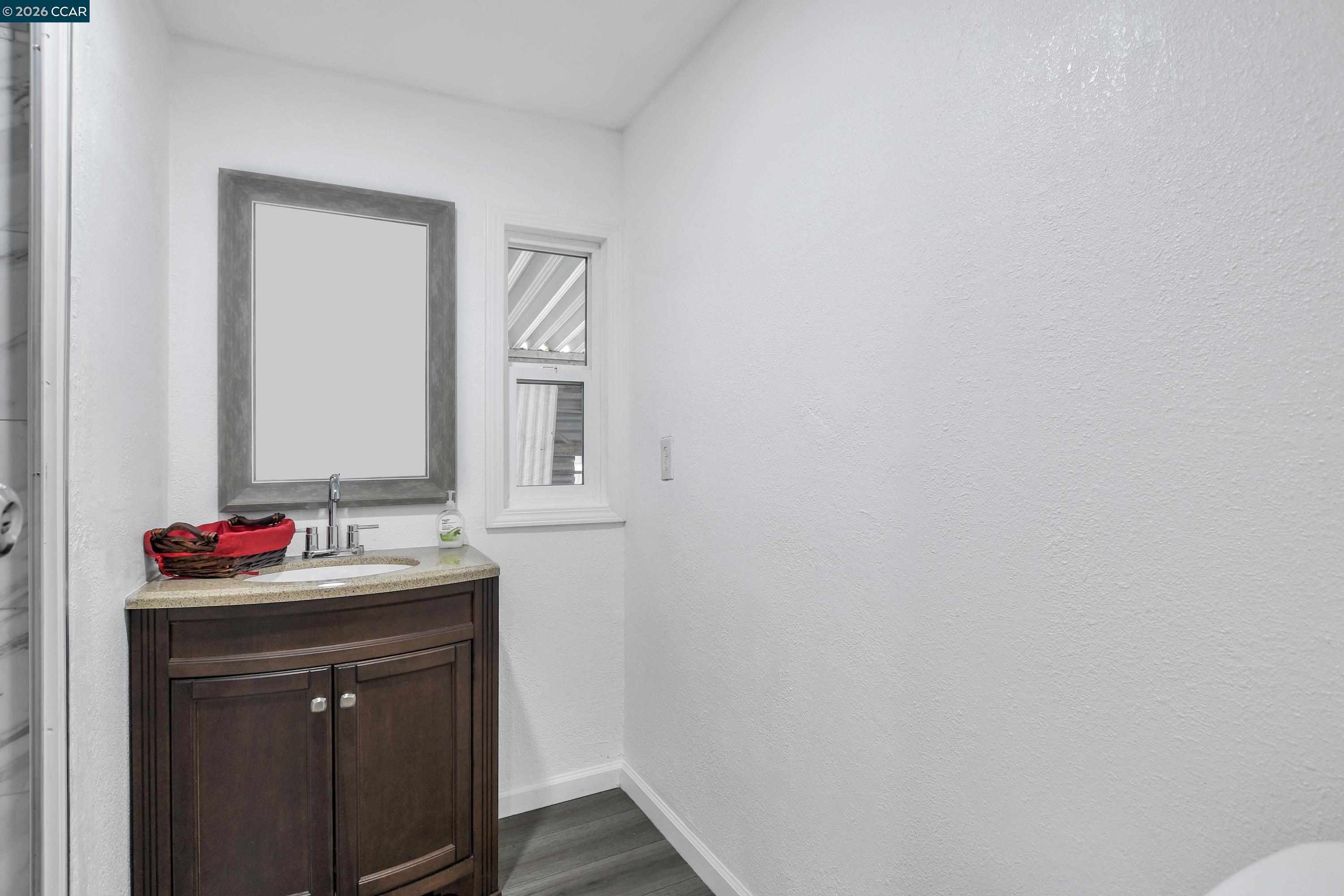 237 Orangevale Pittsburg, CA 94565 - Photo 14 of 21 a bathroom with a sink and a mirror
