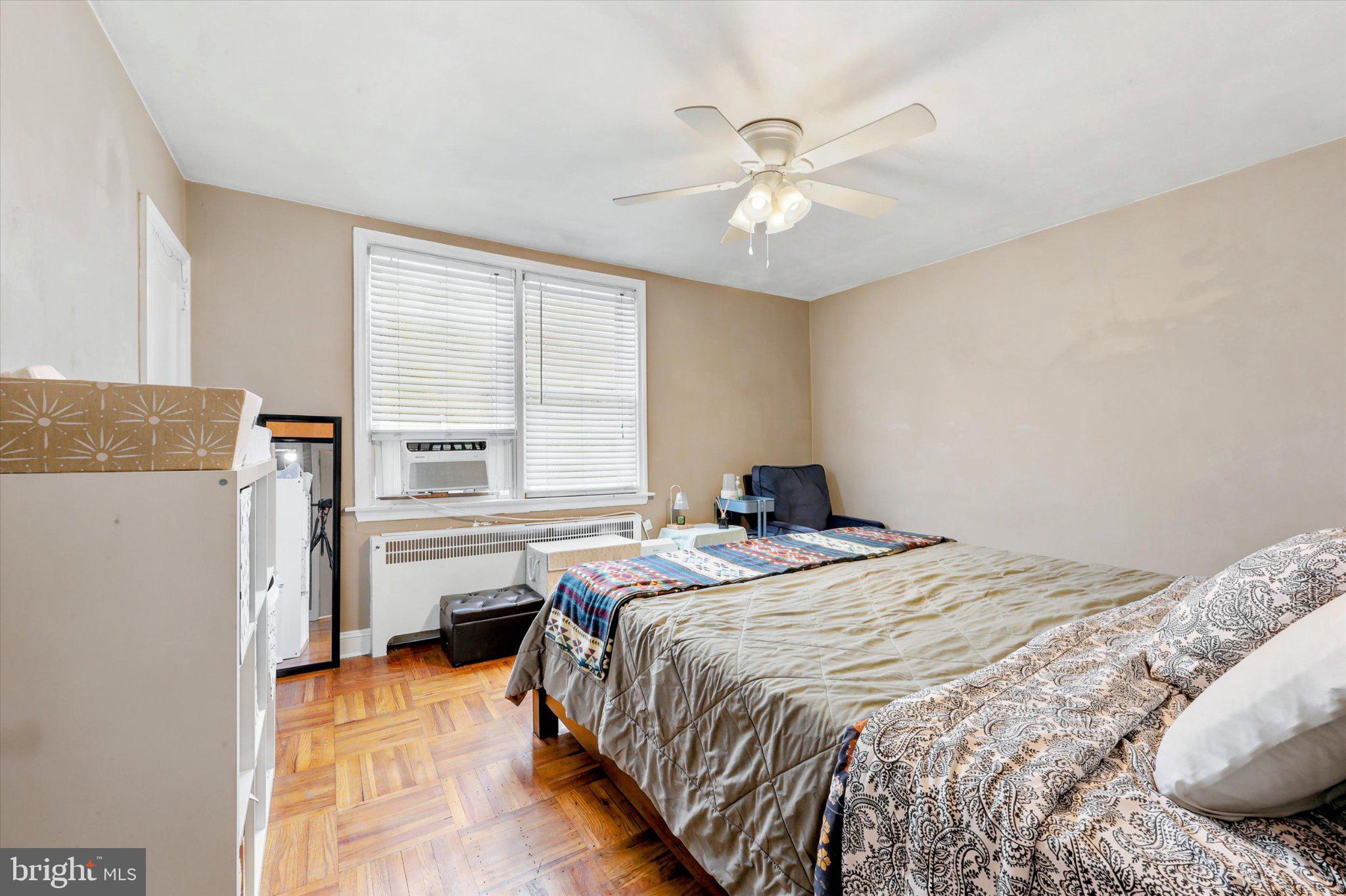 115 Academy Lane Upper Darby, PA 19082 - Photo 11 of 25 a bedroom with a bed and a chandelier