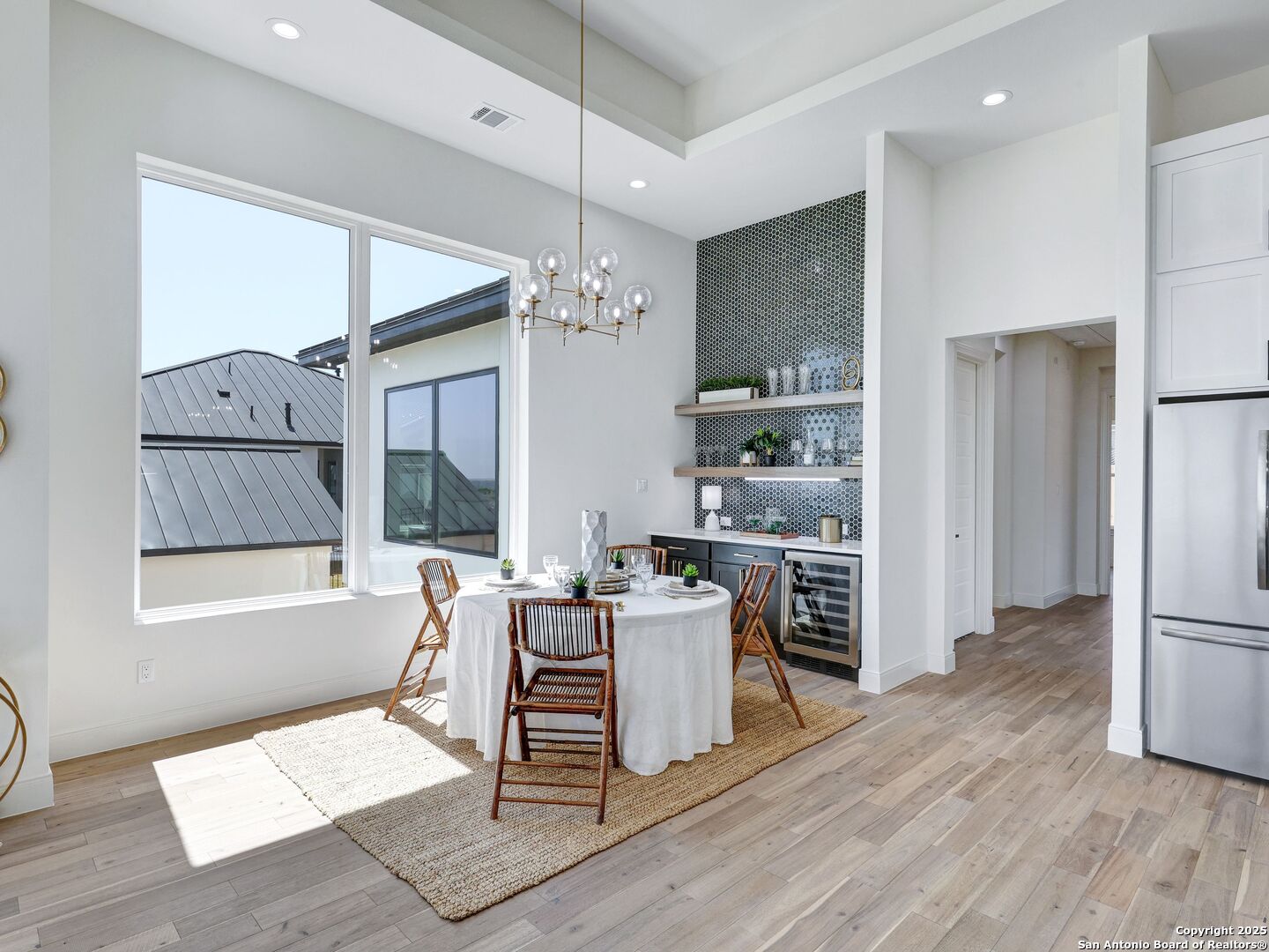 8214 Sierra Hermosa San Antonio, TX 78255 - Photo 12 of 61 a living room with stainless steel appliances kitchen island granite countertop furniture and a wooden floor