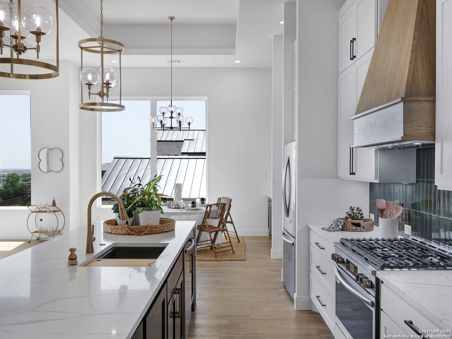 8214 Sierra Hermosa San Antonio, TX 78255 - Photo 14 of 61 a kitchen with stainless steel appliances kitchen island granite countertop a sink a stove and a wooden floors