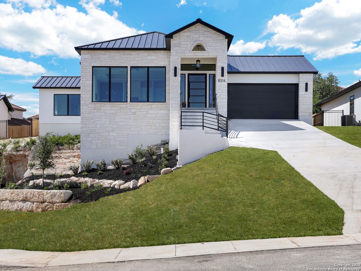 8214 Sierra Hermosa San Antonio, TX 78255 - Photo 2 of 61 a front view of a house with a yard and garage