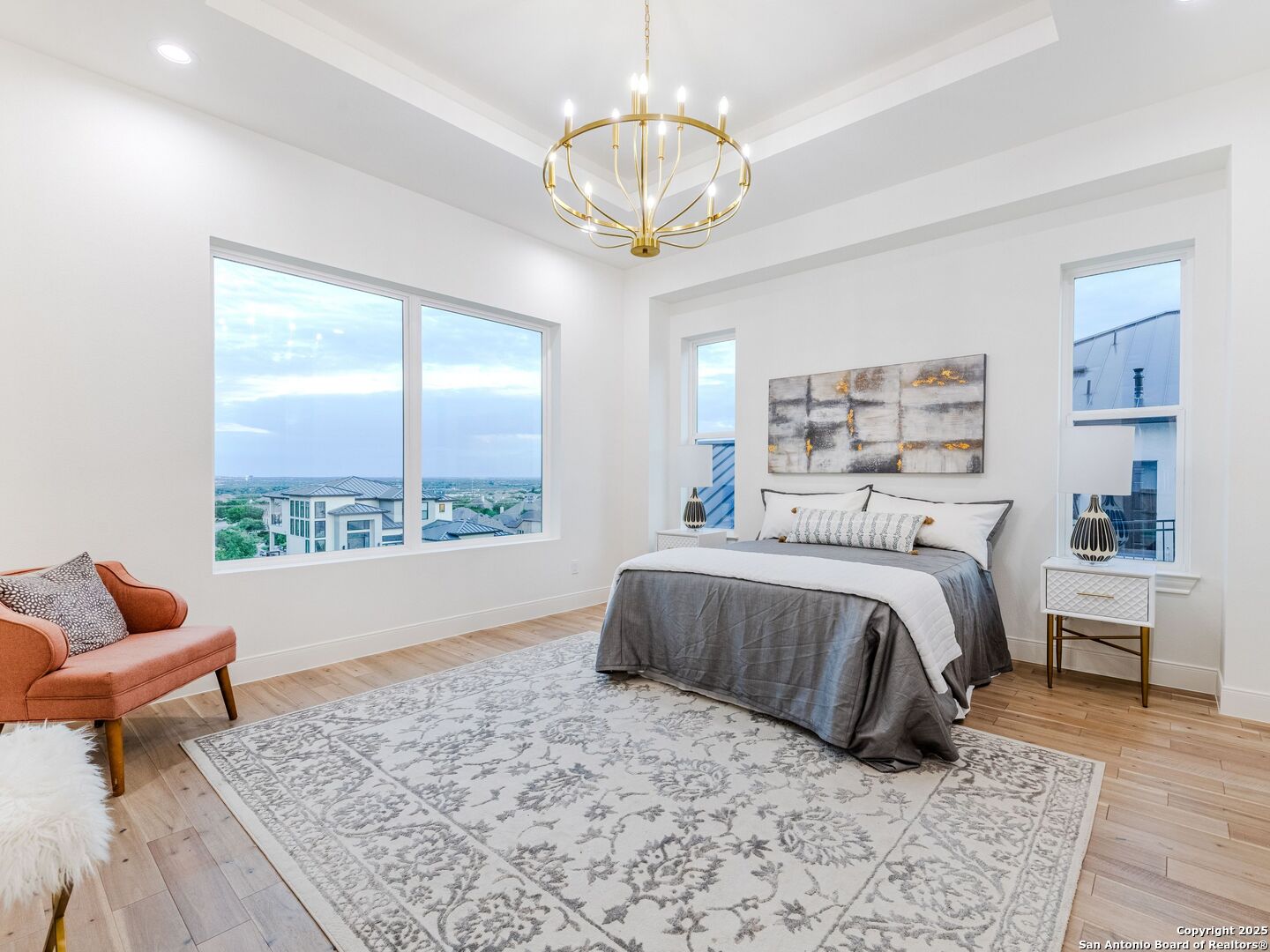8214 Sierra Hermosa San Antonio, TX 78255 - Photo 32 of 61 a bedroom with a bed and a chandelier