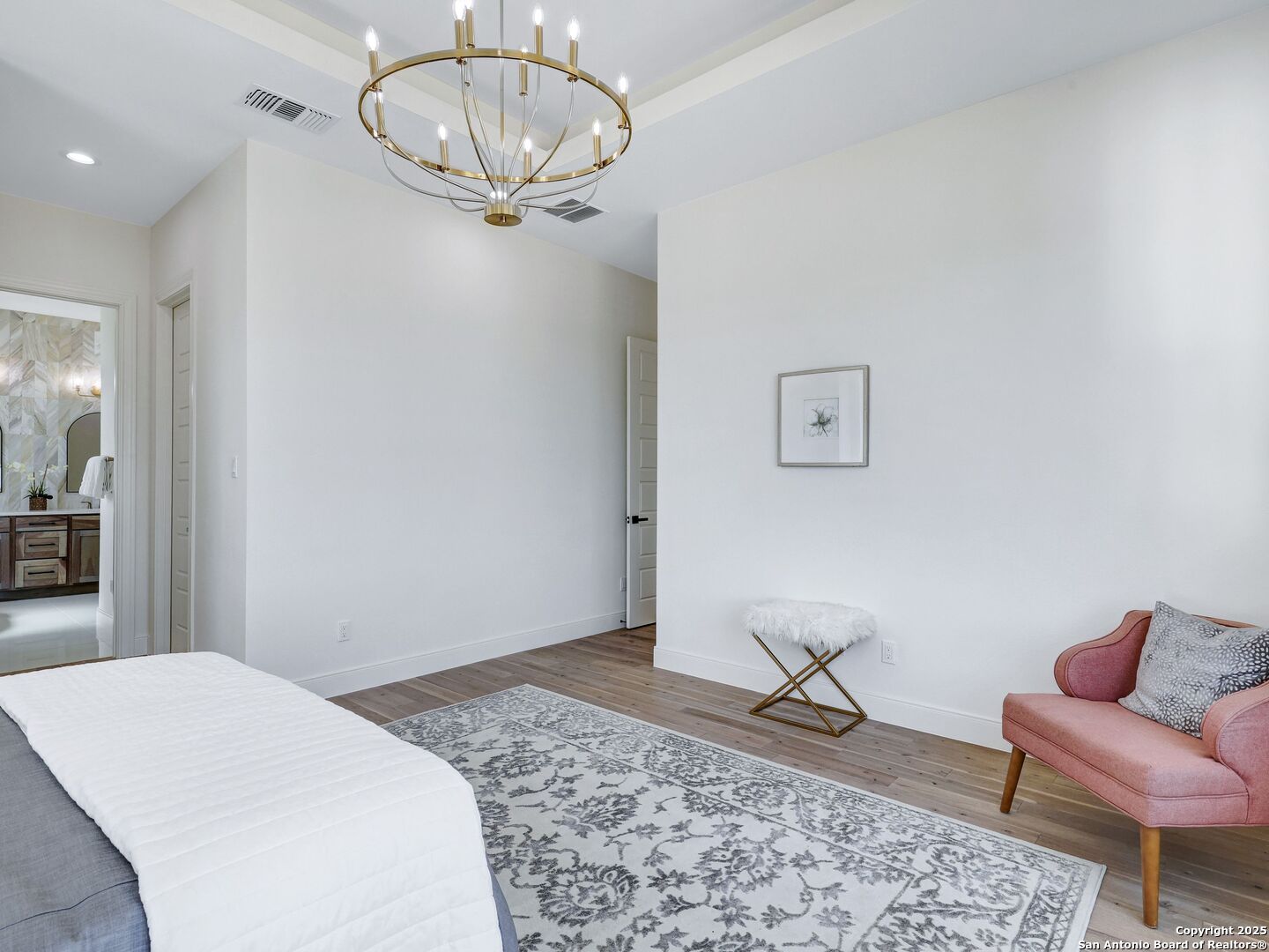 8214 Sierra Hermosa San Antonio, TX 78255 - Photo 35 of 61 a bedroom with a bed and chandelier