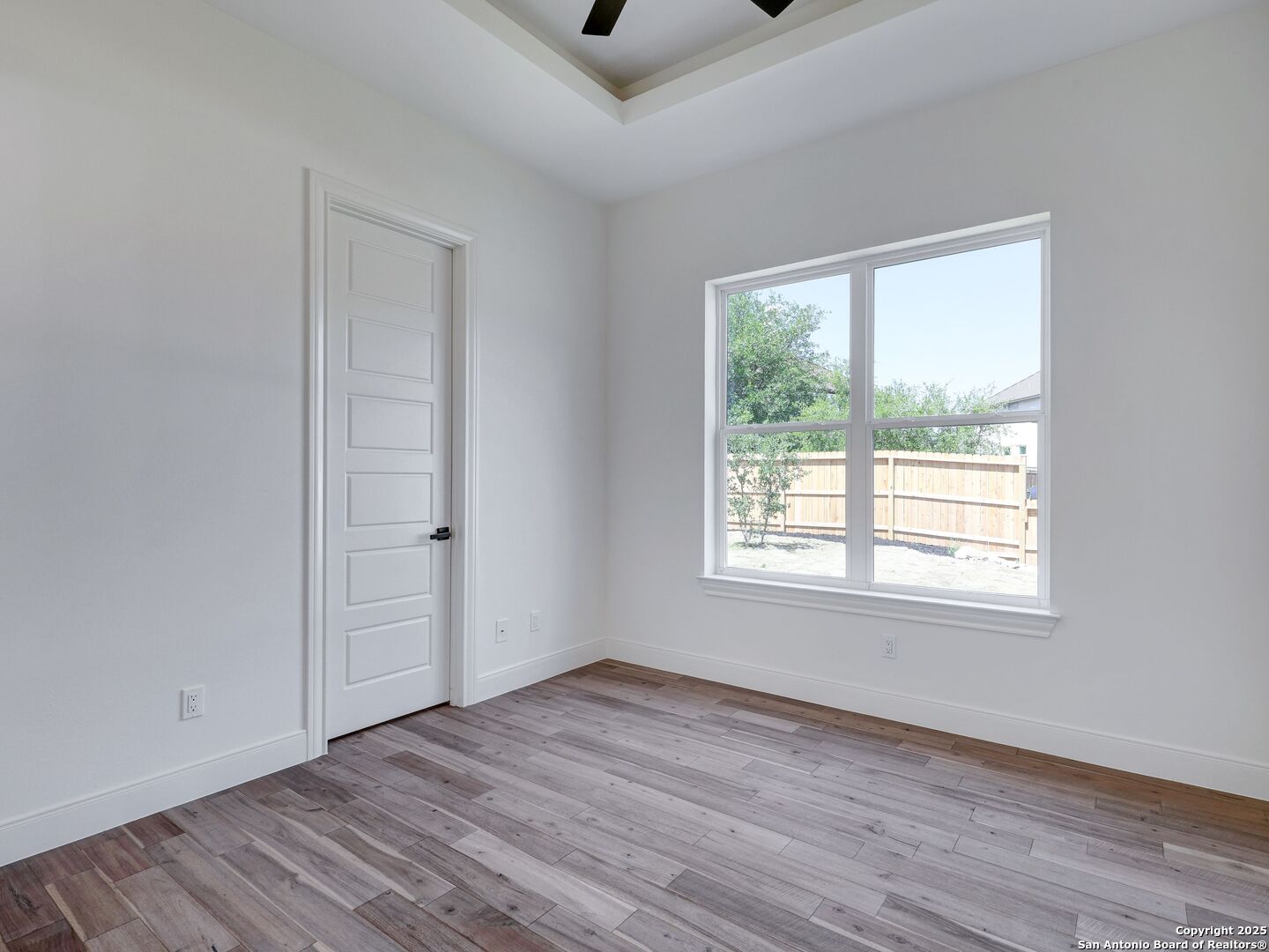 8214 Sierra Hermosa San Antonio, TX 78255 - Photo 43 of 61 a view of an empty room with wooden floor and a window
