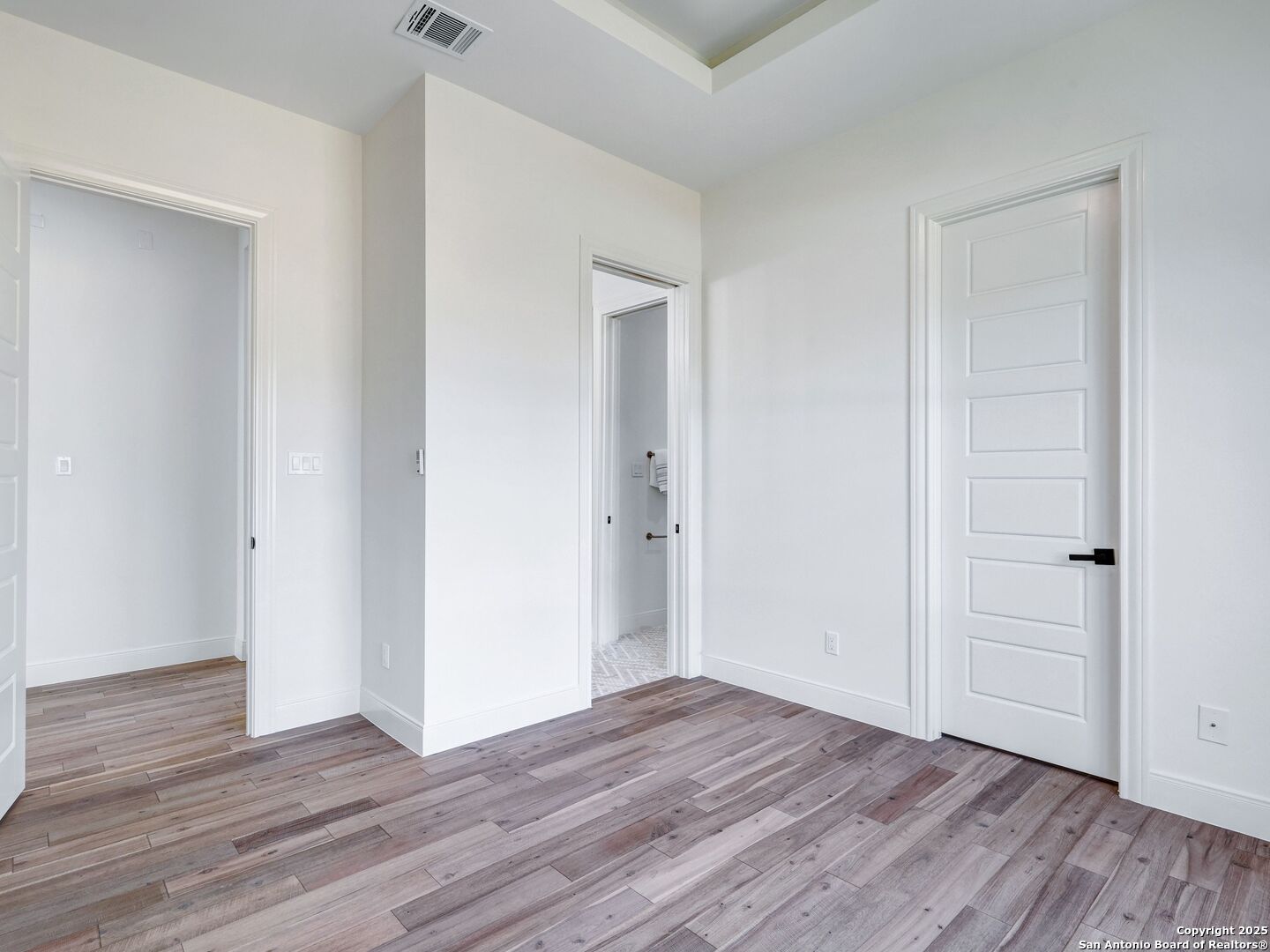 8214 Sierra Hermosa San Antonio, TX 78255 - Photo 44 of 61 a view of a hallway with wooden floor