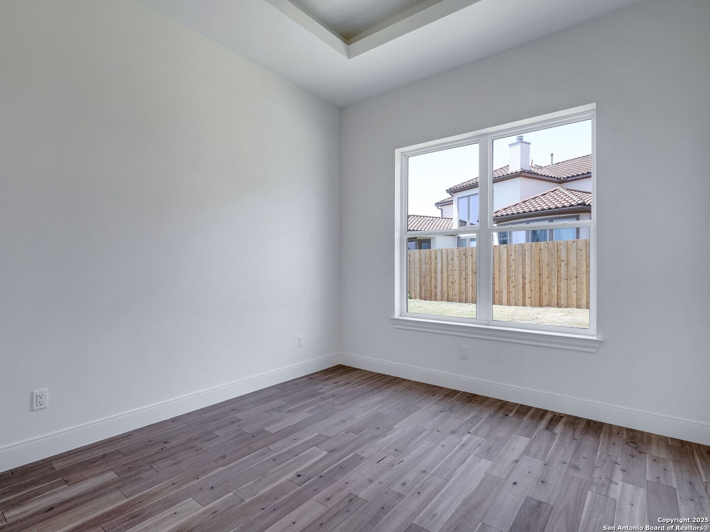 8214 Sierra Hermosa San Antonio, TX 78255 - Photo 47 of 61 a view of an empty room with wooden floor and a window