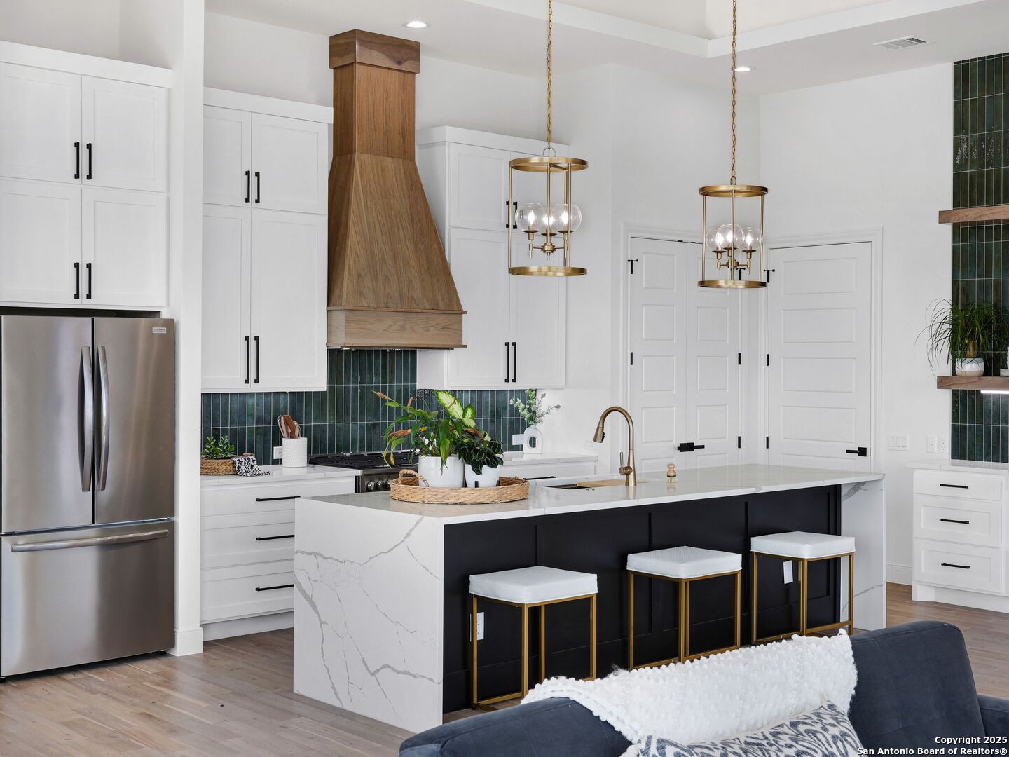 8214 Sierra Hermosa San Antonio, TX 78255 - Photo 7 of 61 a kitchen with white cabinets and stainless steel appliances