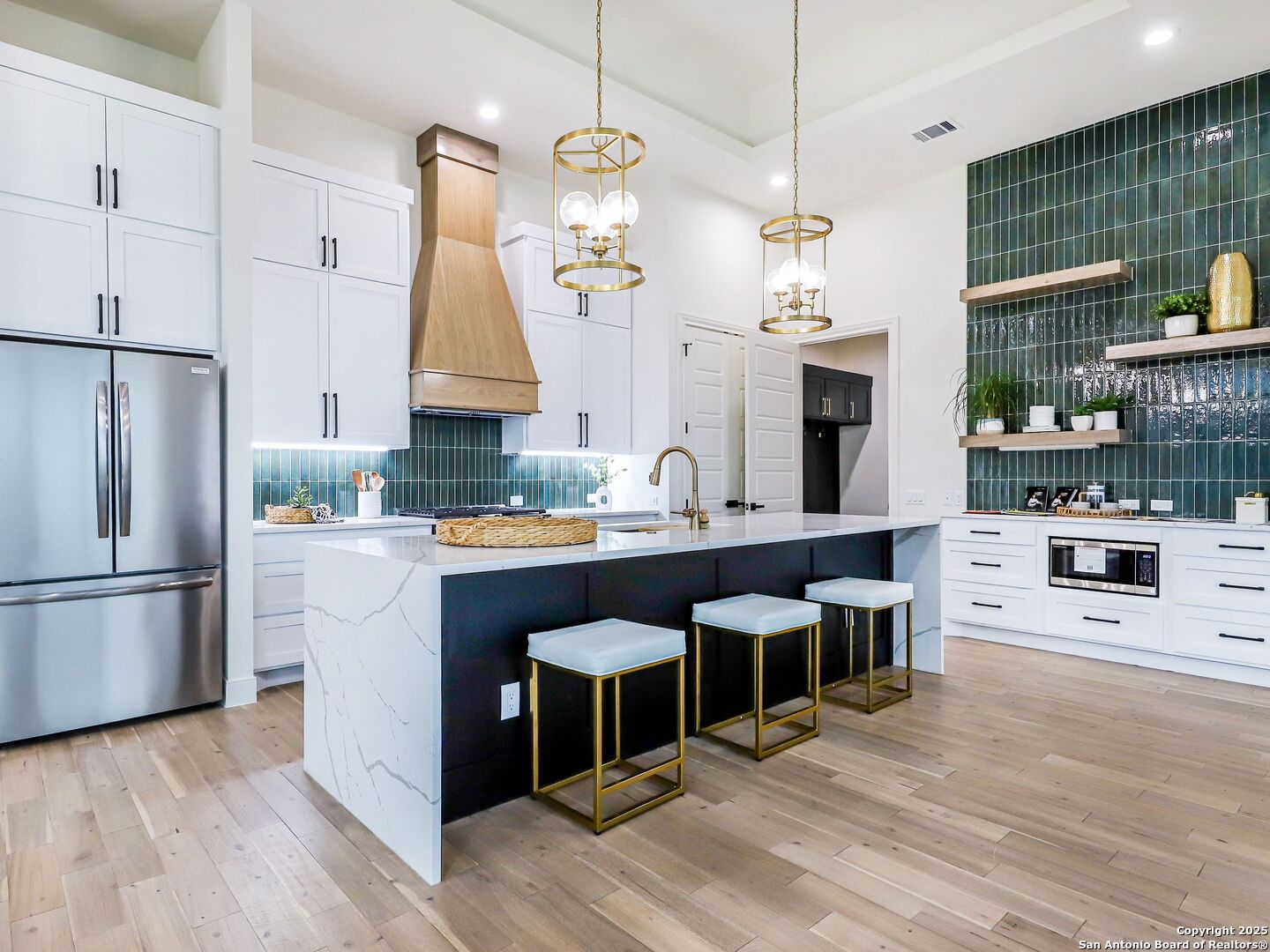 8214 Sierra Hermosa San Antonio, TX 78255 - Photo 9 of 61 a kitchen with stainless steel appliances kitchen island granite countertop a refrigerator a oven a stove and a dining table with wooden floor