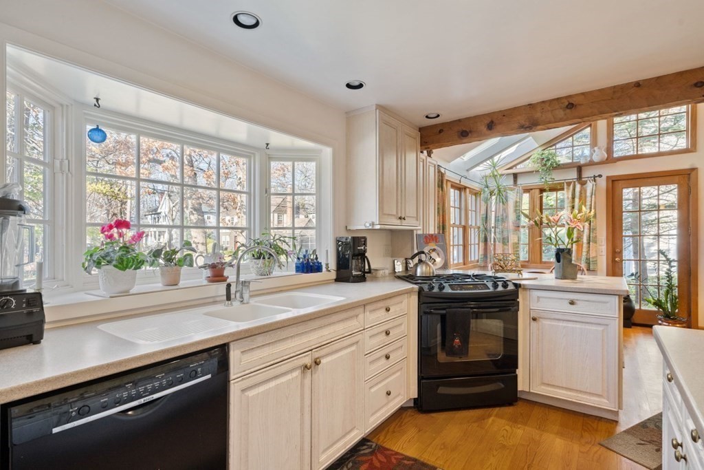 54 Manchester Road Newton, MA 02461 - Photo 11 of 40 a kitchen with a sink stove and cabinets