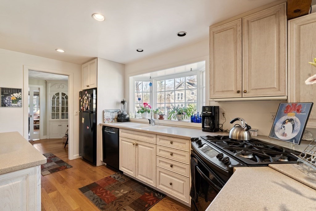 54 Manchester Road Newton, MA 02461 - Photo 12 of 40 a kitchen with stainless steel appliances granite countertop a stove and a refrigerator