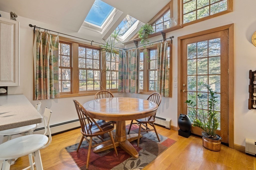 54 Manchester Road Newton, MA 02461 - Photo 15 of 40 a dining room with furniture and floor to ceiling windows