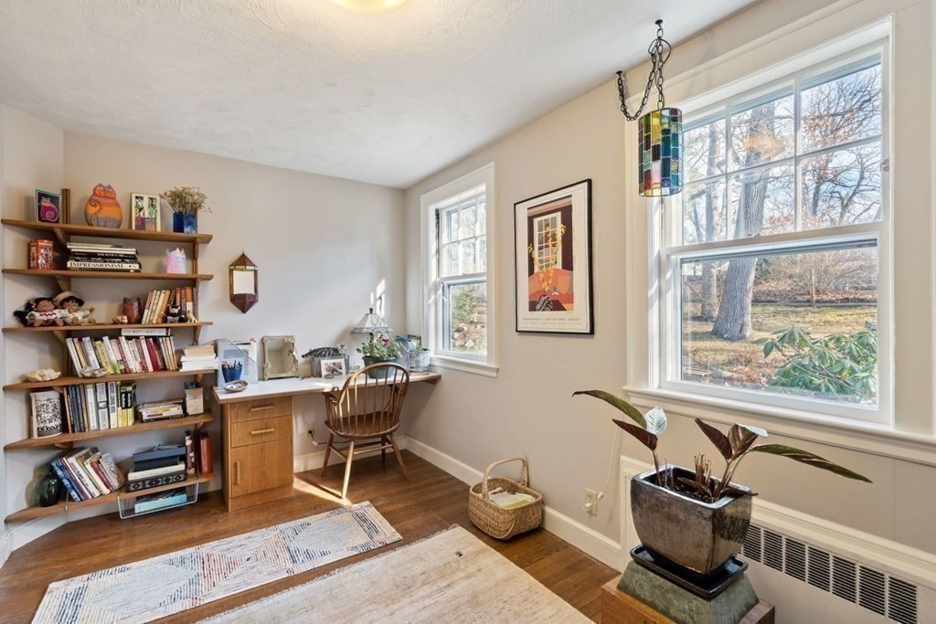 54 Manchester Road Newton, MA 02461 - Photo 21 of 40 a living room with furniture a bookshelf and a window