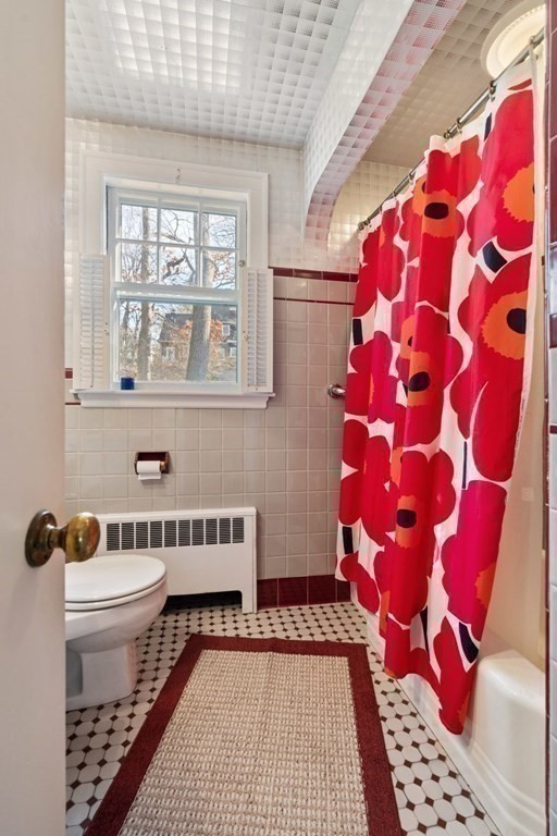 54 Manchester Road Newton, MA 02461 - Photo 24 of 40 a bathroom with a toilet and a shower curtain