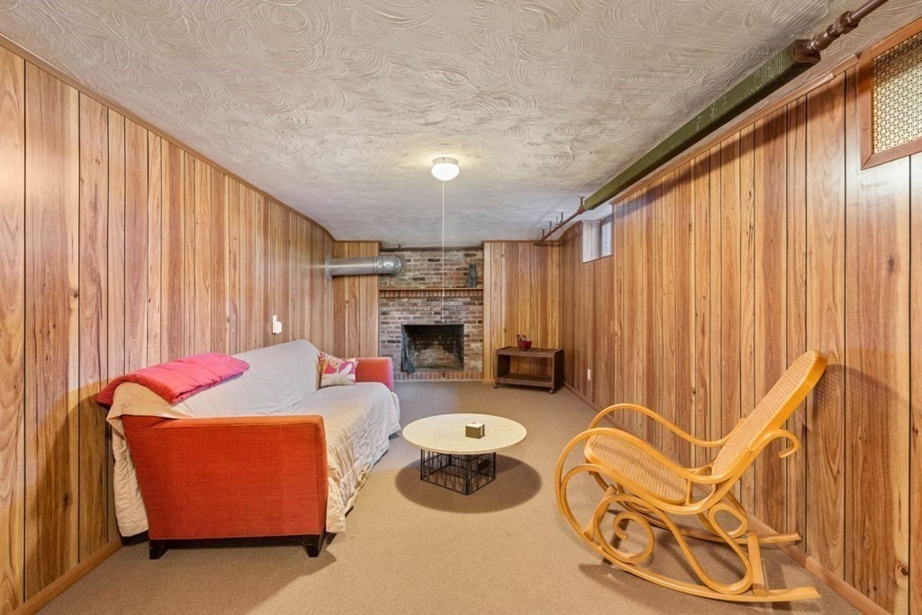 54 Manchester Road Newton, MA 02461 - Photo 27 of 40 a living room with furniture and a fireplace