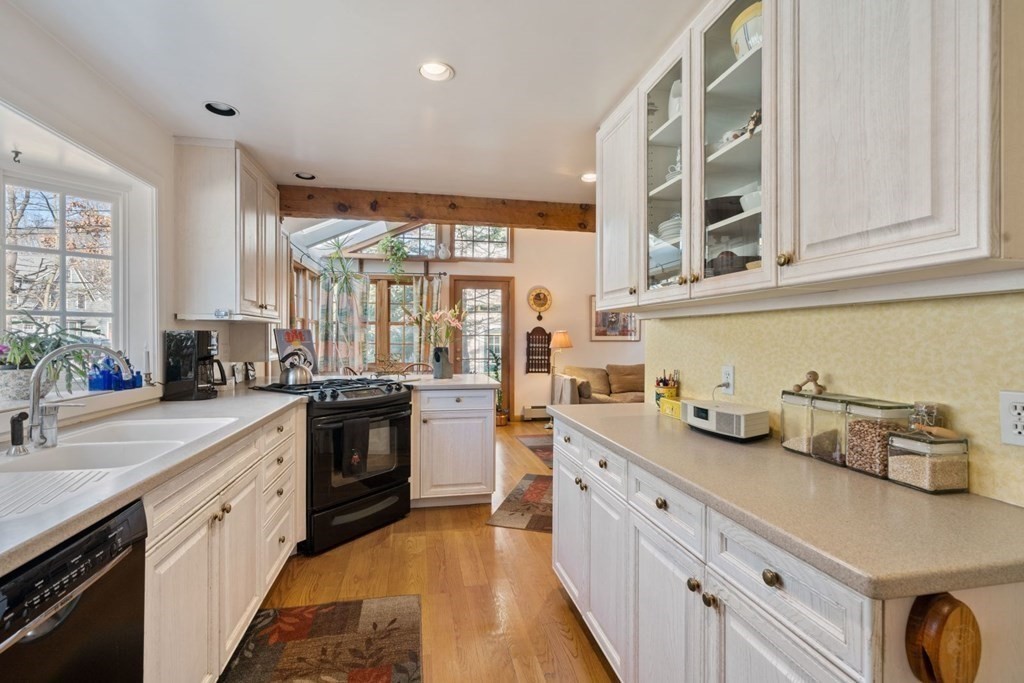 54 Manchester Road Newton, MA 02461 - Photo 10 of 40 a kitchen with stainless steel appliances granite countertop a sink and cabinets