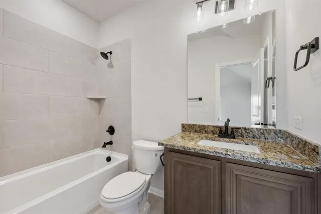 a front view of a house with a garden and yard